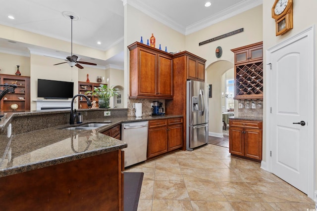 200 Stonefly Ct, Murrells Inlet, SC 29576 - kitchen with a ceiling fan, backsplash, appliances with stainless steel finishes, arched walkways, and a sink