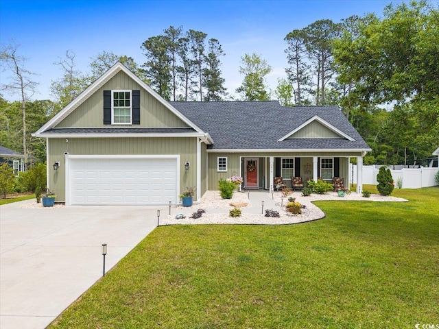 view of front facade featuring covered porch, fence, driveway, a front lawn, and an attached garage
