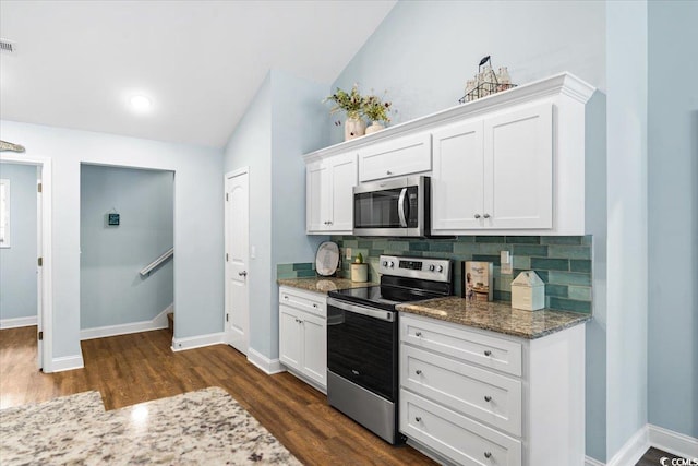 kitchen with white cabinets, stainless steel appliances, baseboards, dark wood-style flooring, and backsplash