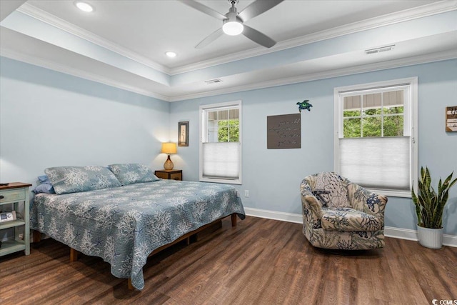bedroom featuring wood finished floors, visible vents, baseboards, and multiple windows