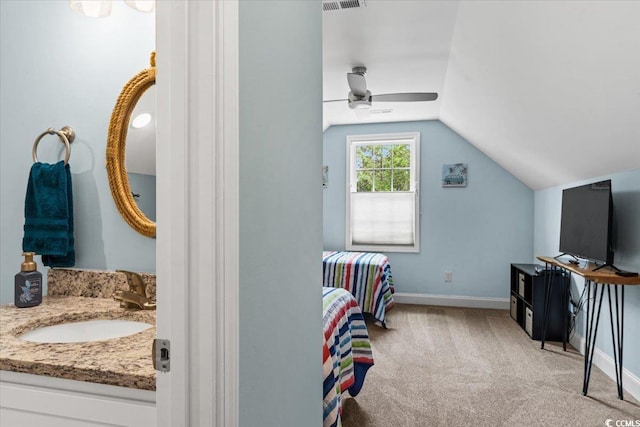 carpeted bedroom with a sink, a ceiling fan, visible vents, vaulted ceiling, and baseboards