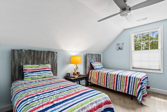 bedroom with carpet flooring, visible vents, baseboards, vaulted ceiling, and a ceiling fan