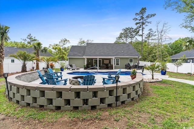 view of pool with a patio, a fenced in pool, a fenced backyard, and an outdoor fire pit
