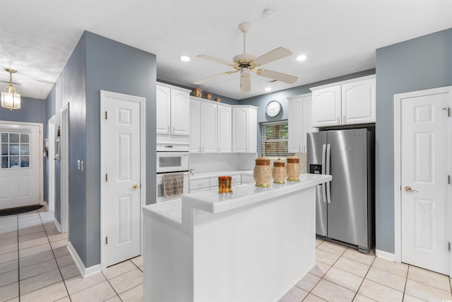 4721 National Dr, Myrtle Beach, SC 29579 - kitchen with light tile patterned floors, tile counters, stainless steel fridge with ice dispenser, and white cabinets