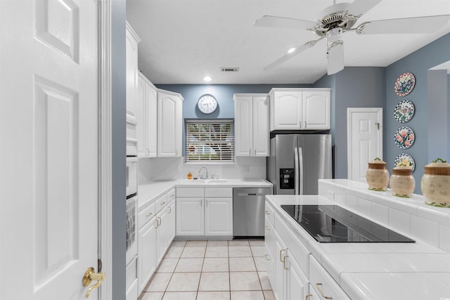 4721 National Dr, Myrtle Beach, SC 29579 - kitchen with a ceiling fan, tile countertops, visible vents, a sink, and appliances with stainless steel finishes