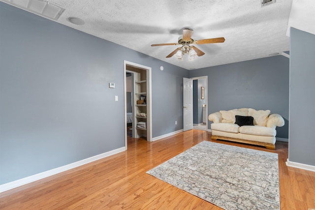 4721 National Dr, Myrtle Beach, SC 29579 - living area with a ceiling fan, a textured ceiling, baseboards, visible vents, and light wood-style floors