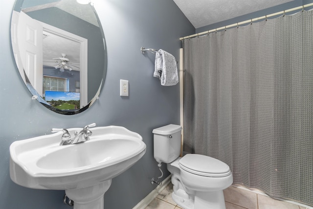 4721 National Dr, Myrtle Beach, SC 29579 - bathroom with toilet, a ceiling fan, a sink, a textured ceiling, and tile patterned flooring