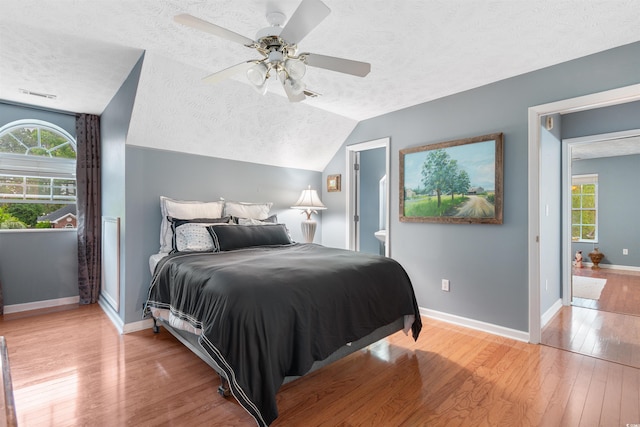 4721 National Dr, Myrtle Beach, SC 29579 - bedroom with lofted ceiling, a textured ceiling, visible vents, light wood-style flooring, and baseboards
