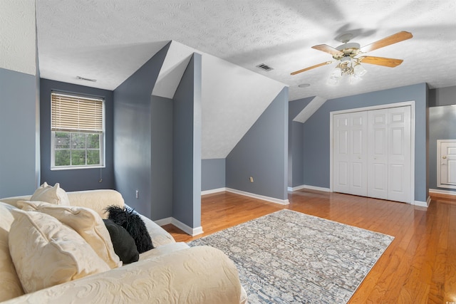 4721 National Dr, Myrtle Beach, SC 29579 - bedroom with vaulted ceiling, a textured ceiling, visible vents, and wood finished floors