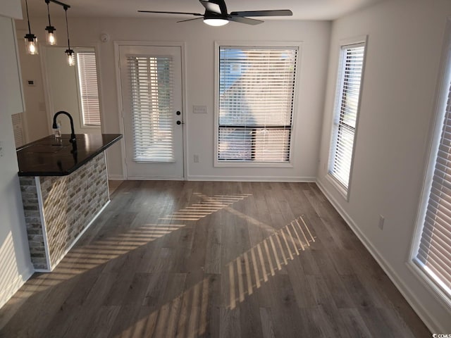 entryway with baseboards, a ceiling fan, a sink, and dark wood-style floors