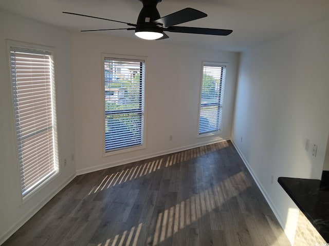 unfurnished room featuring baseboards, a ceiling fan, and wood finished floors