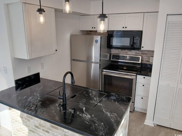 kitchen featuring white cabinets, appliances with stainless steel finishes, a peninsula, backsplash, and pendant lighting