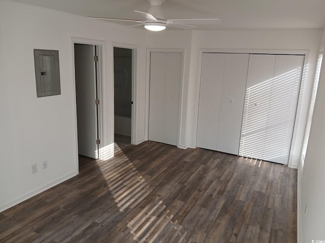 unfurnished bedroom with baseboards, dark wood finished floors, ceiling fan, and electric panel