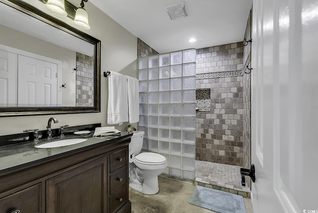 bathroom featuring toilet, vanity, visible vents, and a walk in shower