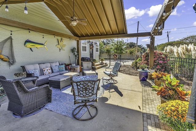 view of patio / terrace featuring ceiling fan, fence, and an outdoor living space