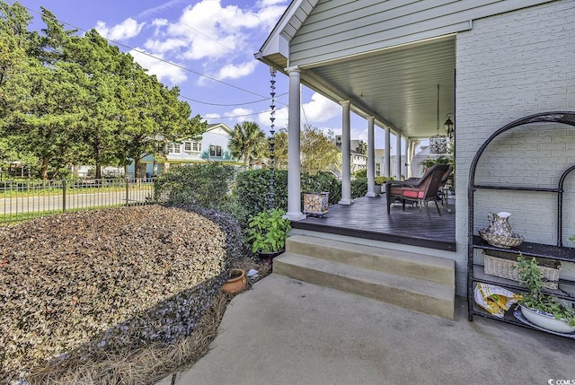view of patio / terrace featuring covered porch and fence