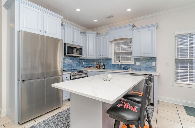 6001-1872 S Kings Hwy, Myrtle Beach, SC 29575 - kitchen with decorative backsplash, a kitchen island, crown molding, appliances with stainless steel finishes, and a sink
