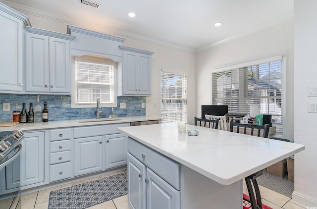 6001-1872 S Kings Hwy, Myrtle Beach, SC 29575 - kitchen with a sink, a kitchen breakfast bar, a center island, decorative backsplash, and stainless steel range oven