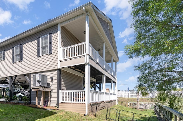 6001-1872 S Kings Hwy, Myrtle Beach, SC 29575 - view of side of property featuring a lawn, fence, and a balcony
