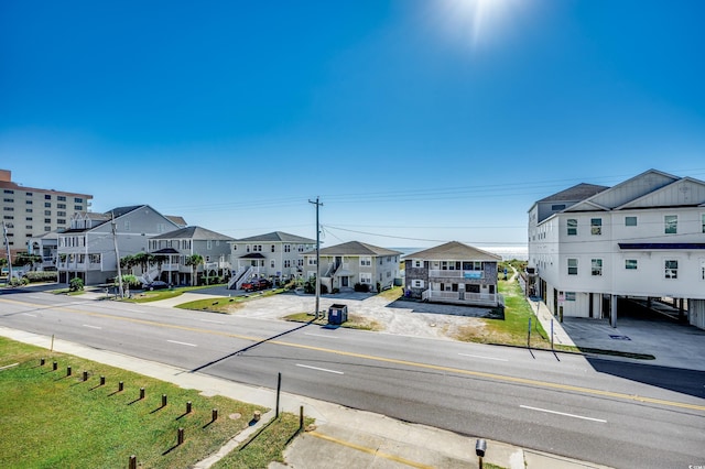 1208 S Ocean Blvd Unit H, North Myrtle Beach, SC 29582 - view of asphalt road with a residential view, sidewalks, and curbs
