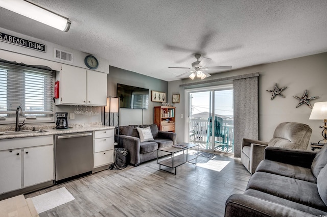 1208 S Ocean Blvd Unit H, North Myrtle Beach, SC 29582 - living area with ceiling fan, light wood-style floors, and a textured ceiling