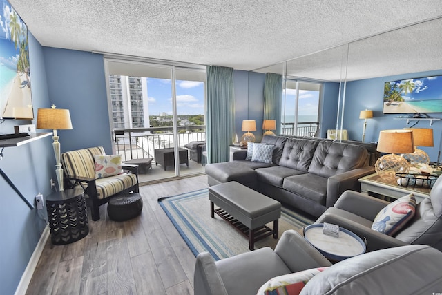 9820 Queensway Blvd Unit 704, Myrtle Beach, SC 29572 - living room with a textured ceiling, floor to ceiling windows, and wood finished floors