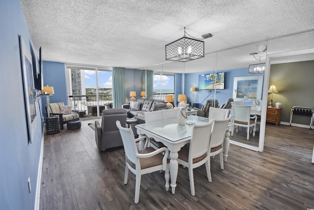 9820 Queensway Blvd Unit 704, Myrtle Beach, SC 29572 - dining room with a textured ceiling, a chandelier, and dark wood-style flooring