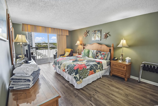9820 Queensway Blvd Unit 704, Myrtle Beach, SC 29572 - bedroom featuring access to outside, a textured ceiling, and wood finished floors