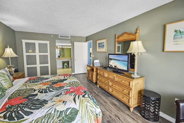 9820 Queensway Blvd Unit 704, Myrtle Beach, SC 29572 - bedroom with wood finished floors and a textured ceiling