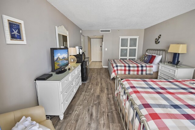 9820 Queensway Blvd Unit 704, Myrtle Beach, SC 29572 - bedroom with dark wood finished floors and a textured ceiling