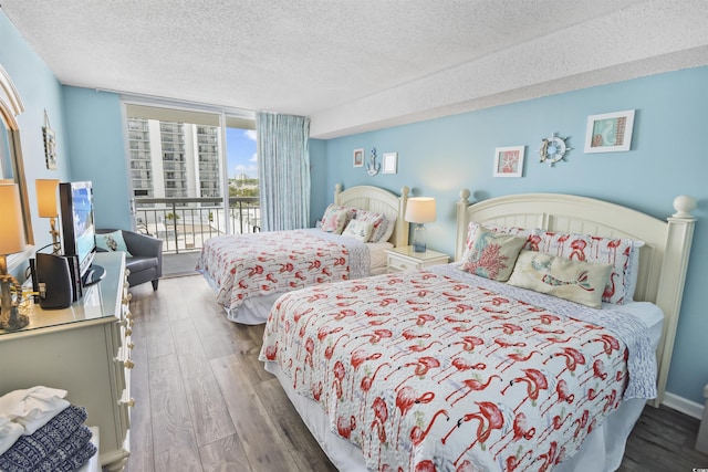 9820 Queensway Blvd Unit 704, Myrtle Beach, SC 29572 - bedroom with access to exterior, a textured ceiling, and wood finished floors