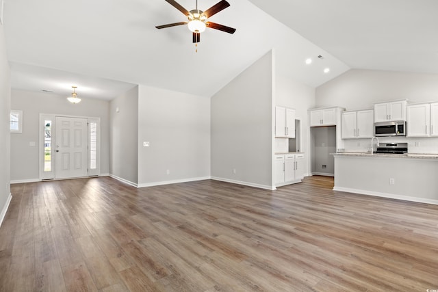 3331 Little Bay Dr, Conway, SC 29526 - unfurnished living room with a ceiling fan, light wood-style flooring, and high vaulted ceiling