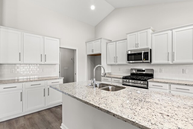 3331 Little Bay Dr, Conway, SC 29526 - kitchen with appliances with stainless steel finishes, white cabinetry, decorative backsplash, light stone countertops, and dark wood-style floors