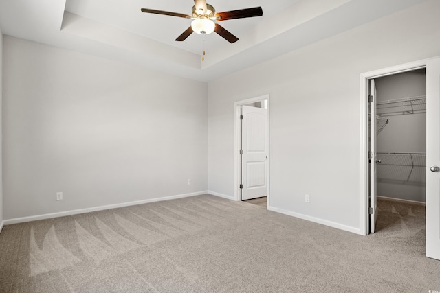 3331 Little Bay Dr, Conway, SC 29526 - unfurnished bedroom featuring carpet floors, a walk in closet, a tray ceiling, a closet, and ceiling fan