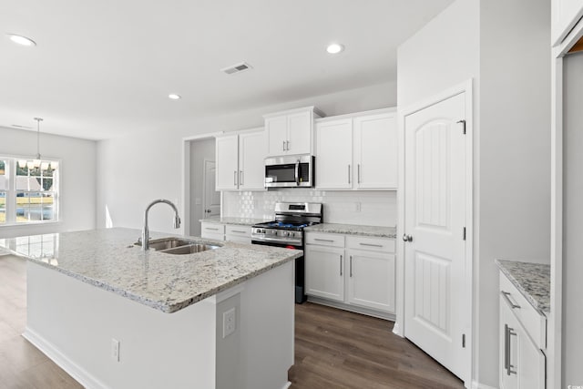 3324 Little Bay Dr, Conway, SC 29526 - kitchen with stainless steel appliances, a sink, decorative backsplash, dark wood-type flooring, and white cabinetry