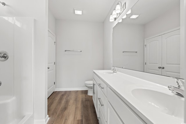 3324 Little Bay Dr, Conway, SC 29526 - bathroom featuring double vanity, wood finished floors, toilet, baseboards, and a shower