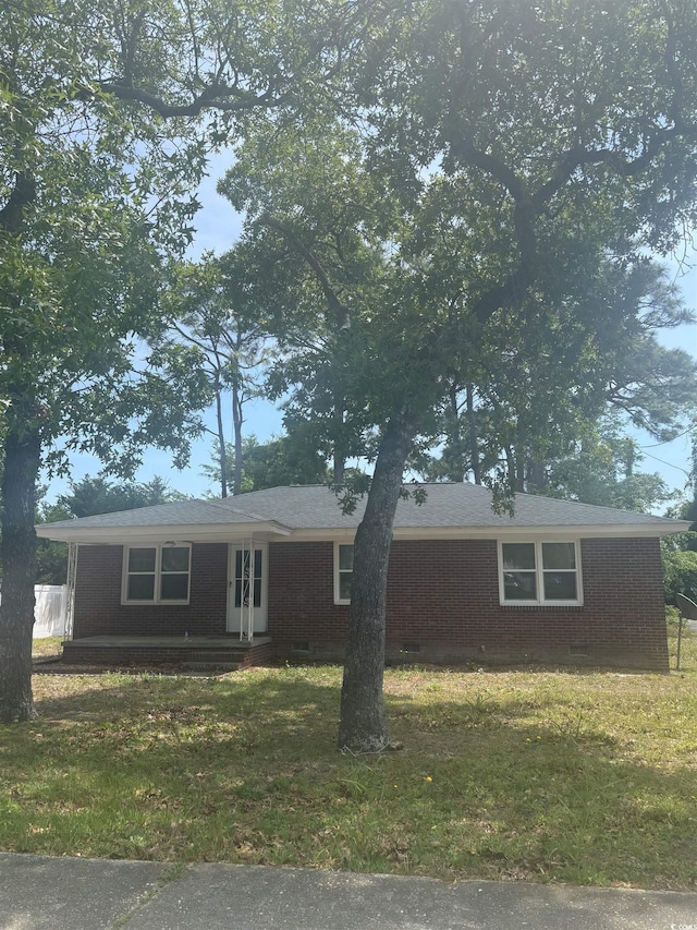 single story home featuring brick siding, a front yard, and crawl space