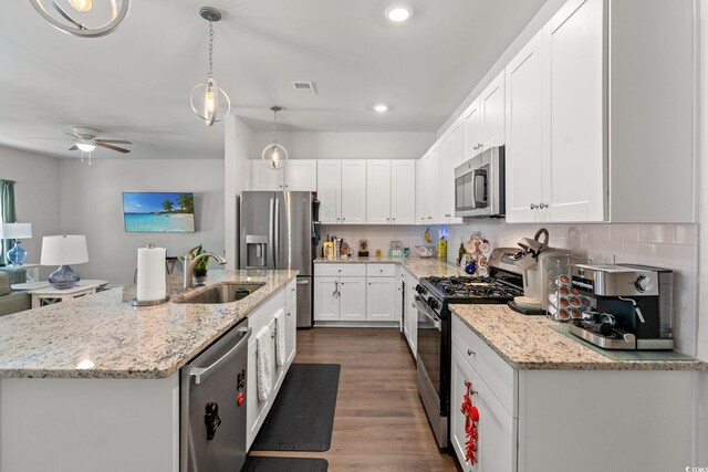 155 Marsh Deer Pl, Surfside Beach, SC 29575 - kitchen featuring stainless steel appliances, ceiling fan, a sink, white cabinetry, and dark wood-style floors