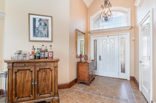 276 Waterfall Cir, Little River, SC 29566 - foyer with a dry bar, a towering ceiling, a notable chandelier, and baseboards