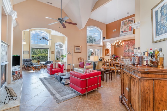 276 Waterfall Cir, Little River, SC 29566 - living area with visible vents, arched walkways, tile patterned floors, high vaulted ceiling, and ceiling fan with notable chandelier