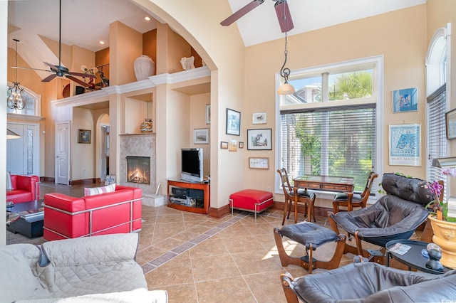 276 Waterfall Cir, Little River, SC 29566 - living room with arched walkways, a tile fireplace, baseboards, high vaulted ceiling, and a ceiling fan