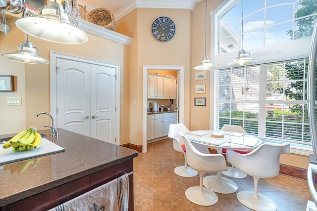 276 Waterfall Cir, Little River, SC 29566 - dining room featuring baseboards, ornamental molding, and a towering ceiling