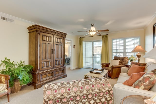 carpeted living room featuring crown molding, a ceiling fan, and visible vents