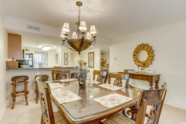 dining area featuring crown molding, light tile patterned flooring, a chandelier, baseboards, and visible vents