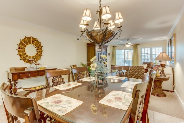 dining room featuring crown molding, baseboards, ceiling fan with notable chandelier, and light tile patterned flooring
