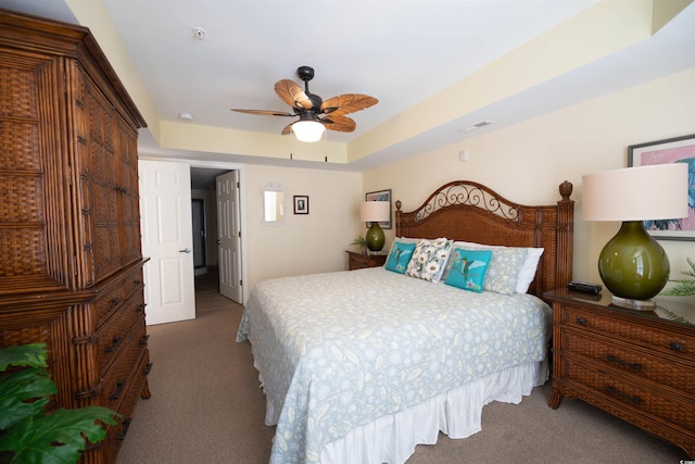 carpeted bedroom with ceiling fan and visible vents