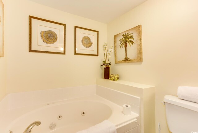 502 48th Ave S Unit 402, North Myrtle Beach, SC 29582 - bathroom featuring toilet and a tub with jets