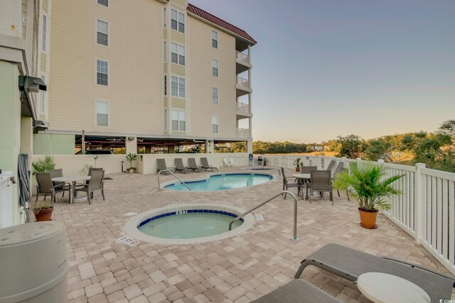 502 48th Ave S Unit 402, North Myrtle Beach, SC 29582 - community pool with a community hot tub, fence, outdoor dining area, and a patio area