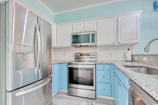 130 Scotch Broom Dr Unit H-103, Little River, SC 29566 - kitchen with ornamental molding, a sink, white cabinets, and stainless steel appliances
