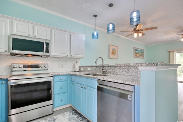 130 Scotch Broom Dr Unit H-103, Little River, SC 29566 - kitchen featuring blue cabinets, stainless steel appliances, ornamental molding, a sink, and a peninsula